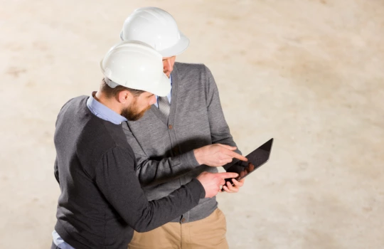 Two construction workers discussing something with each other