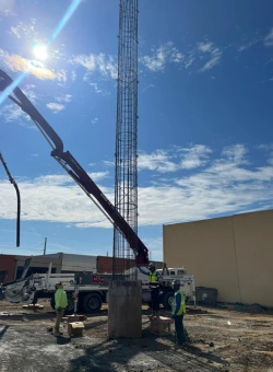 Construction workers putting a frame of steel in a bore